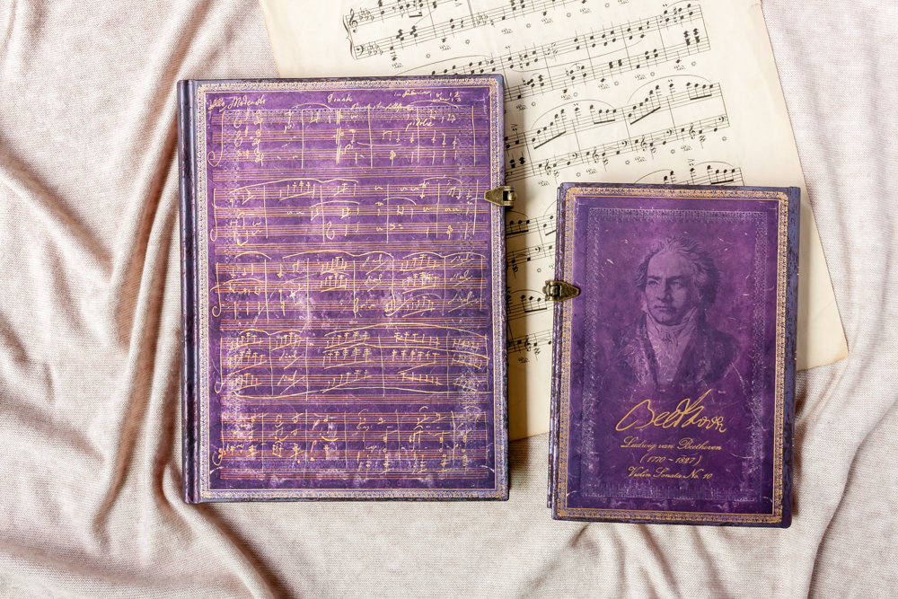 Paperblanks Beethoven's 250th Birthday Special Edition journals featuring a handwritten composition and portrait of Beethoven